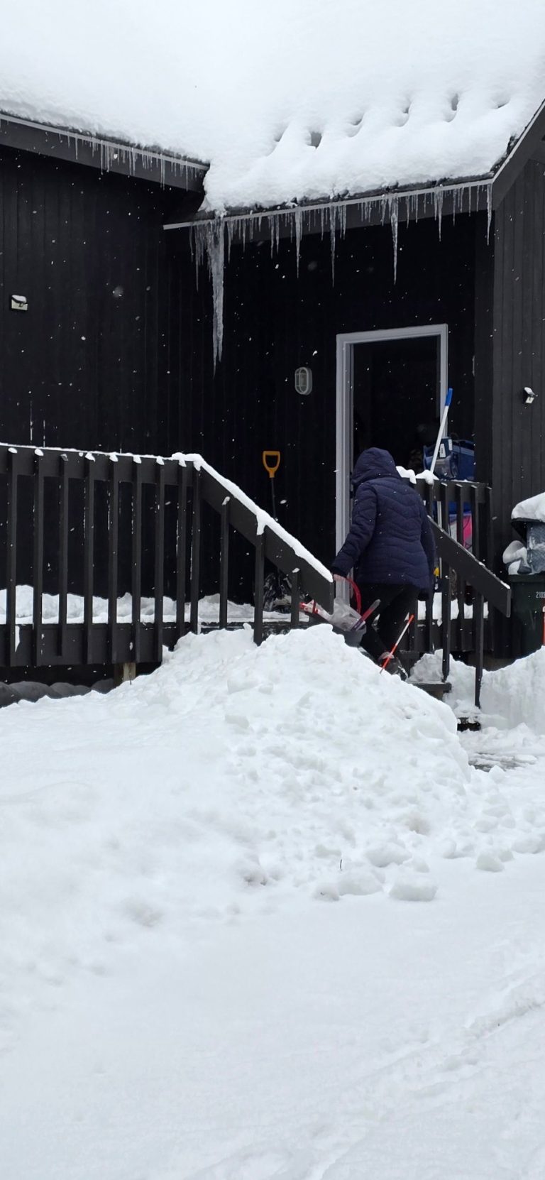 Harbor Shores cleaner arriving at a snowy A-frame vacation rental for a winter turnover